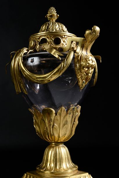 null A blown glass potpourri vase with a chased and gilded bronze mounting, resting...
