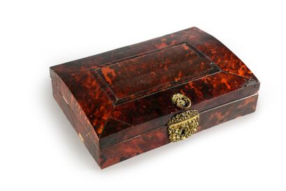 null Writing desk in red tortoiseshell veneer, the curved lid with moldings, lock...