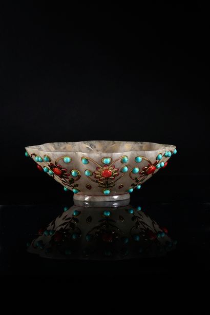 null Flared cup of poly-lobed form carved in milky and translucent nephrite resting...