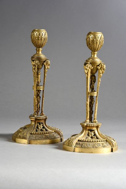 null Pair of Athenian torches in chased and gilded bronze, the shaft formed by a...