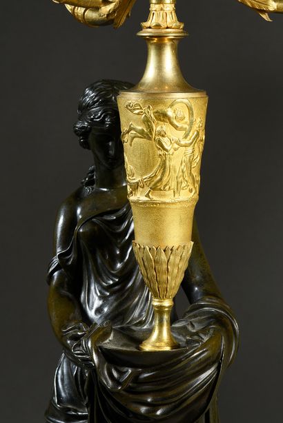 null Pair of girandoles in chased, patinated and gilded bronze, with a figure of...
