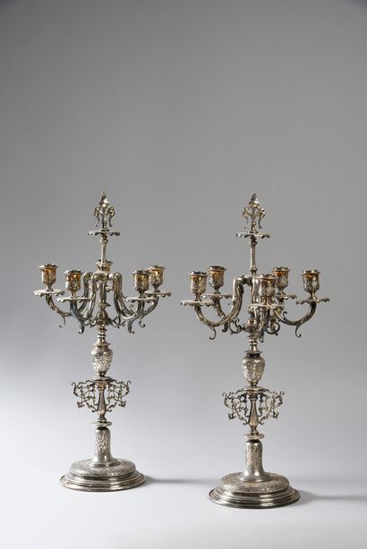 null Pair of candelabra in patinated and gilded bronze, the shaft is flanked by three...