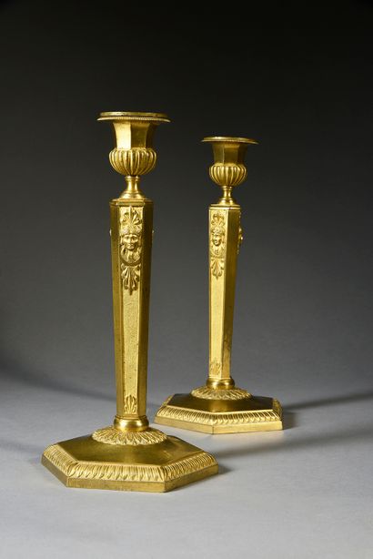 null Pair of chased and gilded bronze torches, with hexagonal shafts, decorated with...