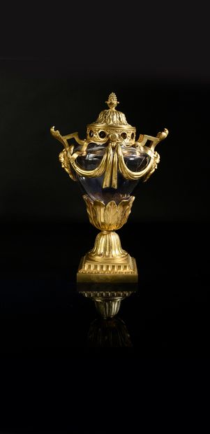 null A blown glass potpourri vase with a chased and gilded bronze mounting, resting...