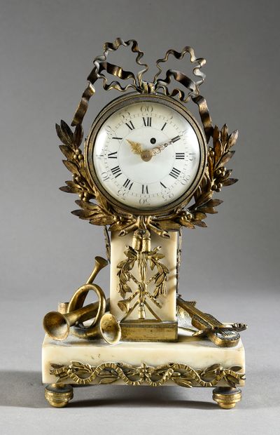 null White marble and gilt bronze clock with a round enamel dial with Roman numerals...