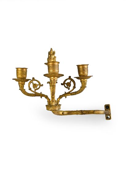 null Pair of overmantel sconces in chased and gilded bronze, the off-center support...