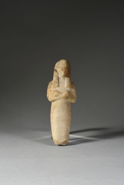 null Mummiform Oushebti representing a standing figure with his arms crossed over...