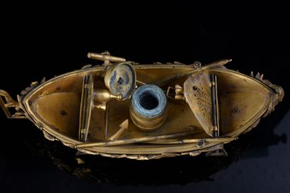 null Inkwell in chased and gilded bronze in the shape of a boat equipped with oars,...