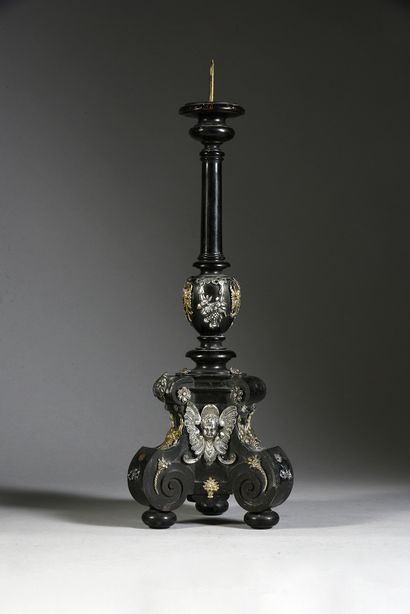 null Tripod candlestick in ebony and silver and gilt appliques, resting on console...
