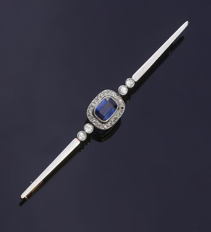 null Two-tone gold barrette brooch, set with an oval faceted blue stone in a rose...
