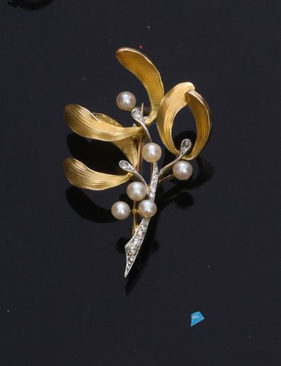 null Brooch in two shades of gold 750e, stylizing a branch of mistletoe, the branch...
