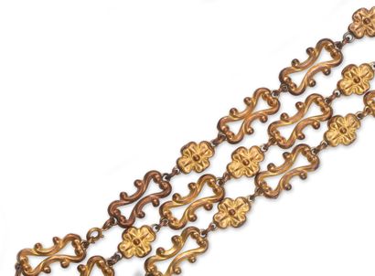 null Long necklace made of gilded metal, composed of links decorated with scrolls,...