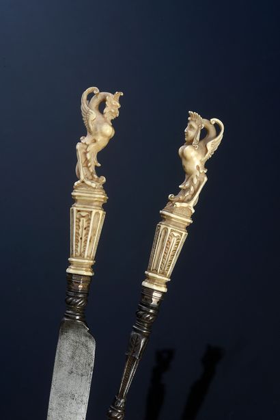 null Knife and fork with two prongs with ivory handle carved with a harpy.
17th century...