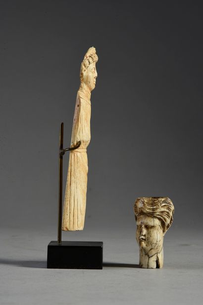 null Two elements in carved bone, one showing a turbaned head, the other a man wearing...