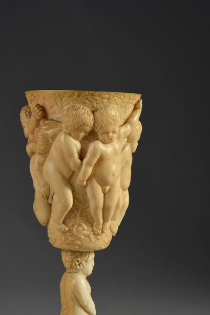 null Carved ivory pokal, circular base decorated with pampers, foot formed of a naked...