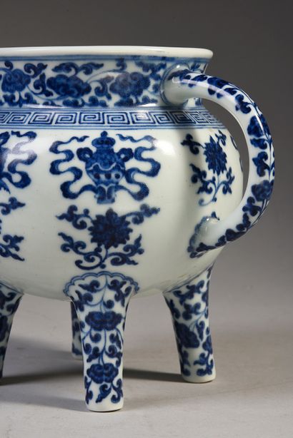 null Porcelain four-legged pot with white-blue decoration of Buddhist symbols.
Bears...