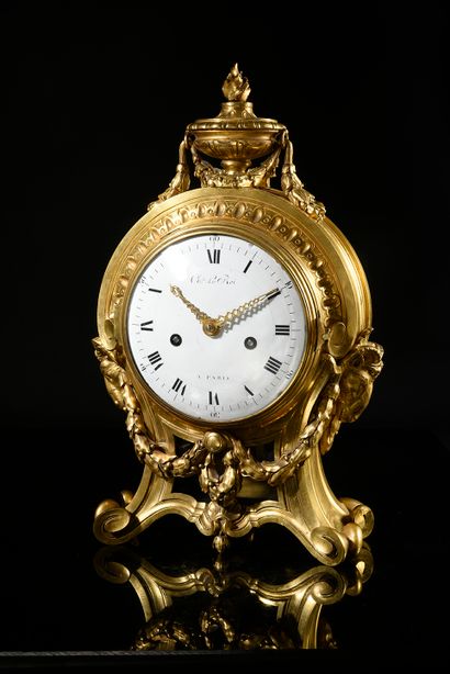 null Chased and gilded bronze clock, resting on scrolled feet, the enamelled dial...