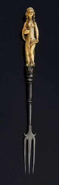 null Three-pronged fork with ivory handle carved in the round with a nude woman.
17th...