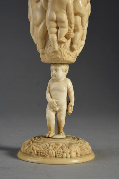 null Carved ivory pokal, circular base decorated with pampers, foot formed of a naked...