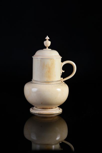 null Turned ivory pitcher, globular body, high neck, lid with spinning top, handle.
Germany,...