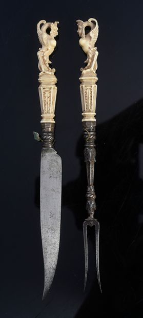 null Knife and fork with two prongs with ivory handle carved with a harpy.
17th century...
