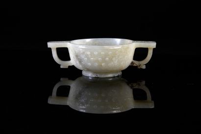 null Celadon jade bowl with two engraved handles, the body with nailhead motifs.
Qing...