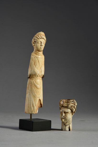 null Two elements in carved bone, one showing a turbaned head, the other a man wearing...