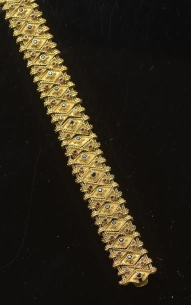 null Un bracelet souple en or jaune, orné sur deux fils de motifs géométriques coulissants...