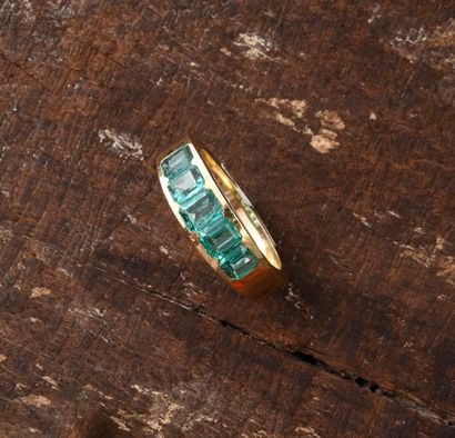 Gold ring set with five rectangular emeralds.
TDD...