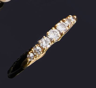 Half wedding ring in 18K gold, set with a...