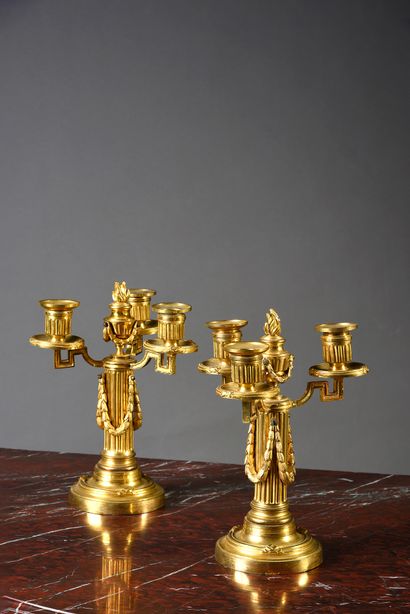 Pair of candelabras in chased and gilded...