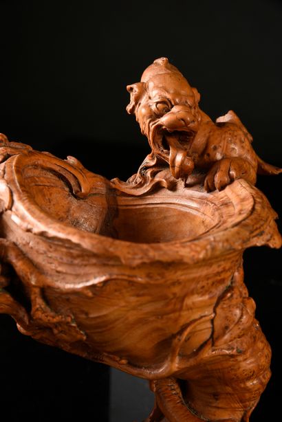 null Cedar burl cup carved in the round with a winged dragon drinking from a horn-shaped...