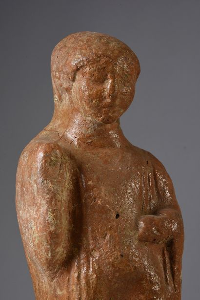 null Votive statuette representing a character standing on a high parallelepiped...