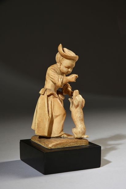 Young girl playing with a dog in ivory carved...