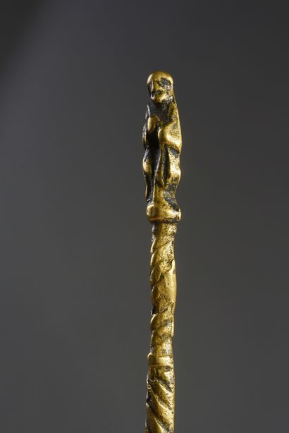null Bronze spoon with twisted handle and figure of a saint at the end; hallmark...