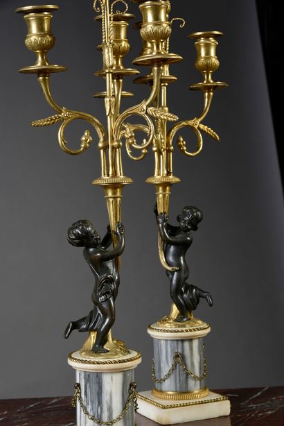 null Pair of candelabras in patinated bronze, gilt bronze with three arms of light.
Base...
