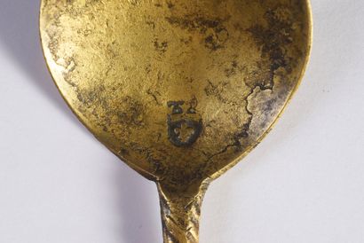 null Bronze spoon with twisted handle and figure of a saint at the end; hallmark...