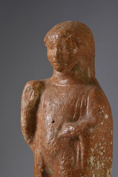 null Votive statuette representing a character standing on a high parallelepiped...