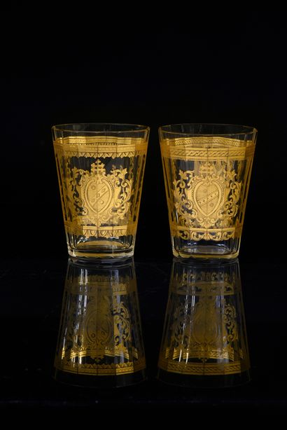 null Two cut glass goblets, each with a fine gilt decoration of a fame and a coat...