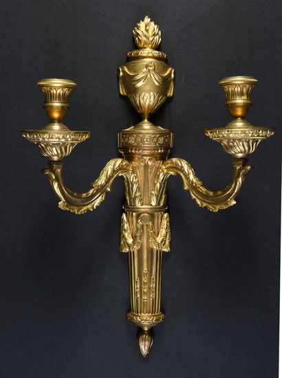 null Pair of two light sconces in gilded and chased bronze showing a fine interlacing...