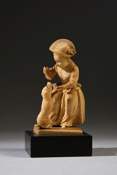 null Jeune fille jouant avec un chien en ivoire sculpté en ronde-bosse.
XVIIIe siècle...