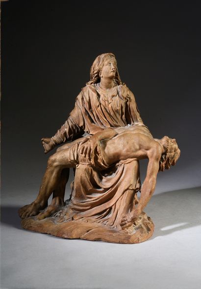 Virgin of Pity in terracotta. Mary, seated...