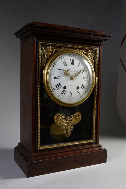 null Mahogany clock with brass fillet decoration, the movement on a glass base decorated...