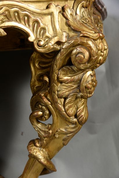 null Carved and gilded wood console, the belt with openwork decoration of shells...