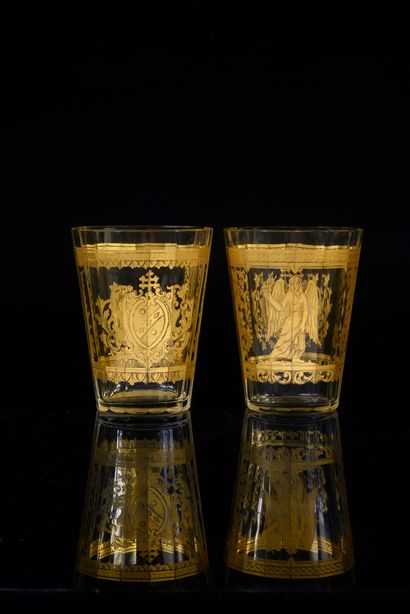 null Two cut glass goblets, each with a fine gilt decoration of a fame and a coat...