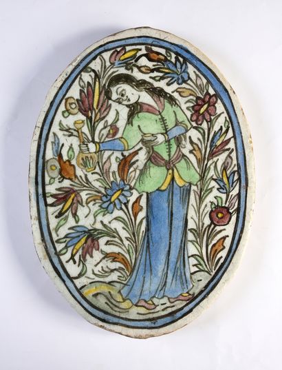 null Oval Qadjar tile in siliceous paste decorated with a woman with a carafe on...