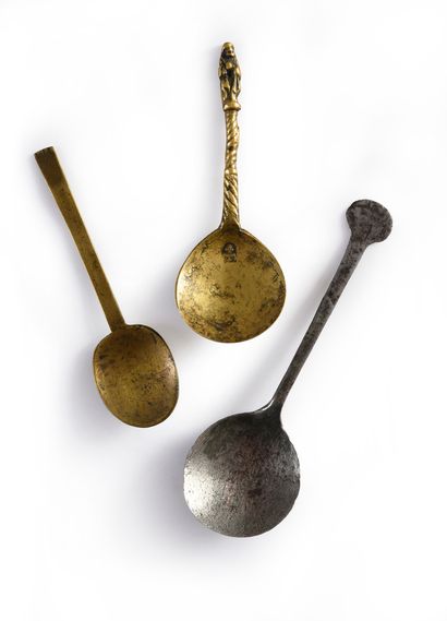 null Bronze spoon with twisted handle and figure of a saint at the end; hallmark...