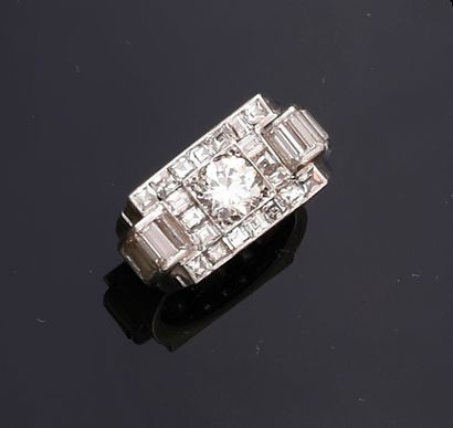 null 850th platinum tank ring, centered on an old-cut diamond in a pavement of square-cut...