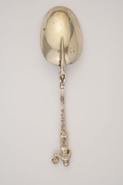 null Silver rat tail spoon with melted handle and foliage pattern ending with a woman...