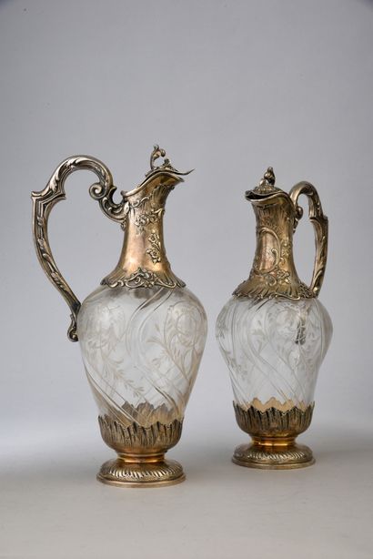 null Pair of silver and crystal ewers of rocaille style, resting on a circular base...